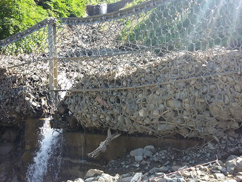 Flexible mudslide barriers