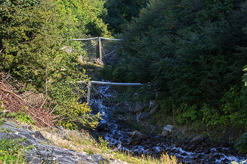 Flexible mudslide barriers