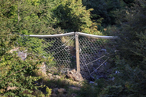Flexible mudslide barriers