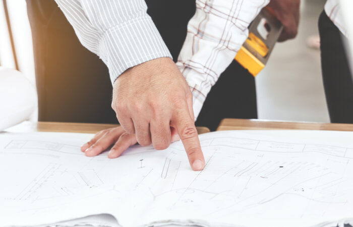 Team engineers working with construction tools on table
